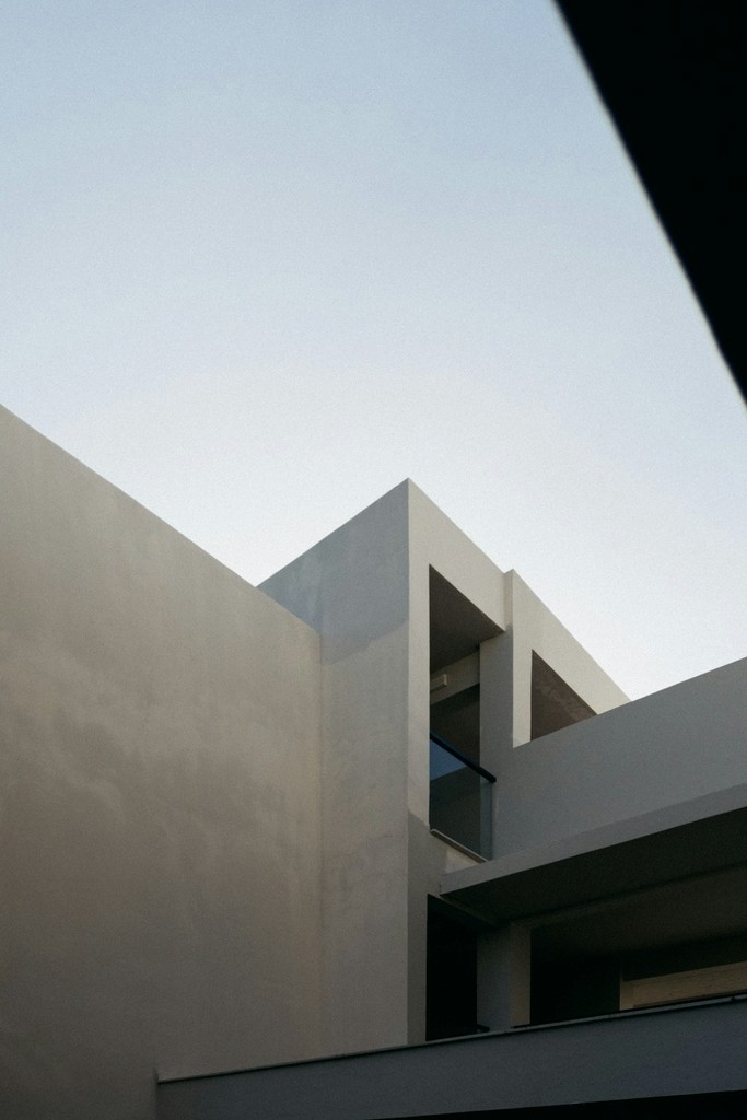 Concrete building facade against a pale sky